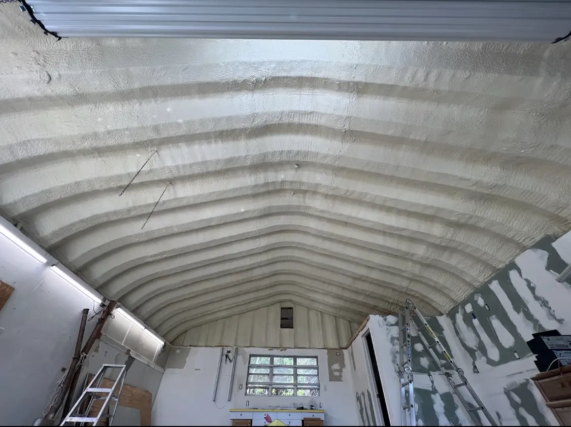 Spray polyurethane foam applied to the underside of a metal roof deck in Latimer